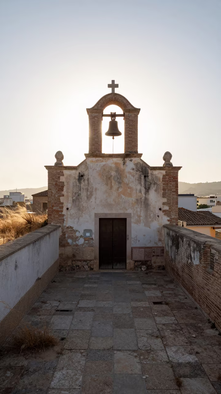Rusted Bell in Roofless Malaga Schoolhouse Nave in inside a roofless nave near Malaga