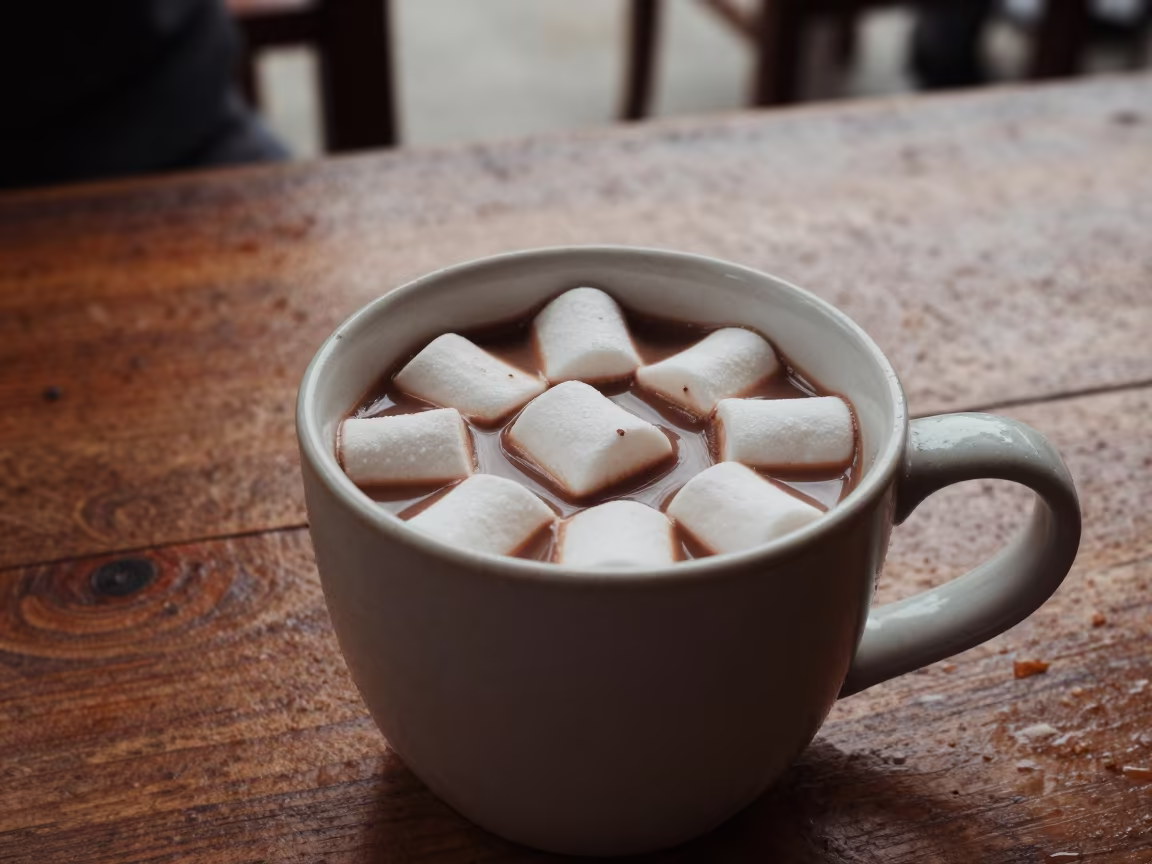 Rustic Wooden Table Hot Chocolate with Marshmallows in on a rustic wooden table in Abidjan