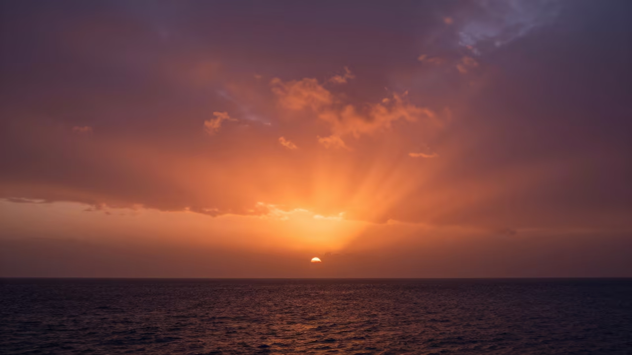 Saharan Dust Plume Over Atlantic Sunset Bahrain in beneath fast-moving cloud bands in Bahrain