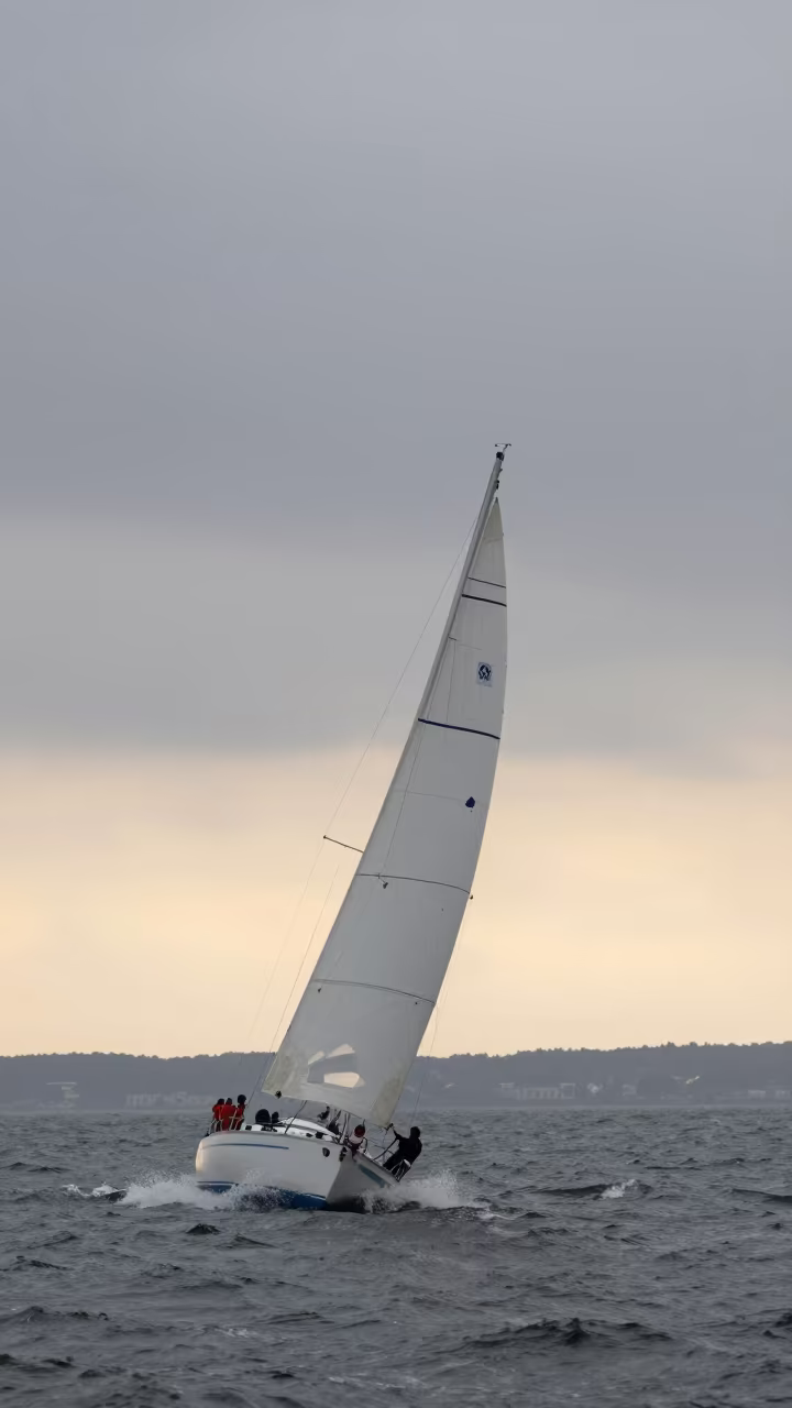 Sailboat Heeling in Bursa Ferry Crossing Drizzle in across a remote ferry crossing near Bursa