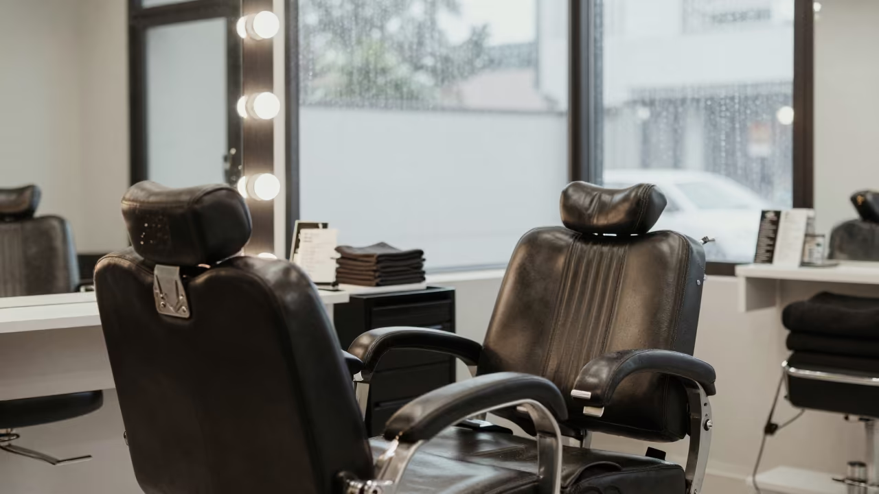 Salon Chair Window Light Bhubaneswar Midday Rain in at a barber station beneath mirror bulbs in Bhubaneswar