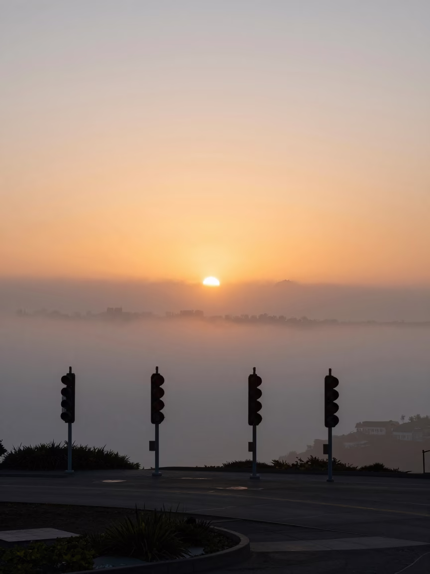 San Francisco Sunset Fog Rolling Over Signal Gantry Above Parallel Rail Lines in in San Francisco, California, United States