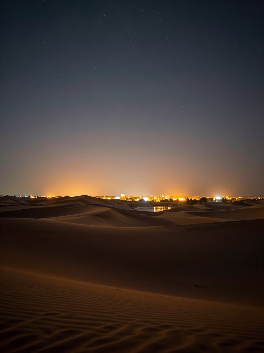 Sand Dunes Under Stars Near Isfahan City Lights in across a wide valley floor near Isfahan