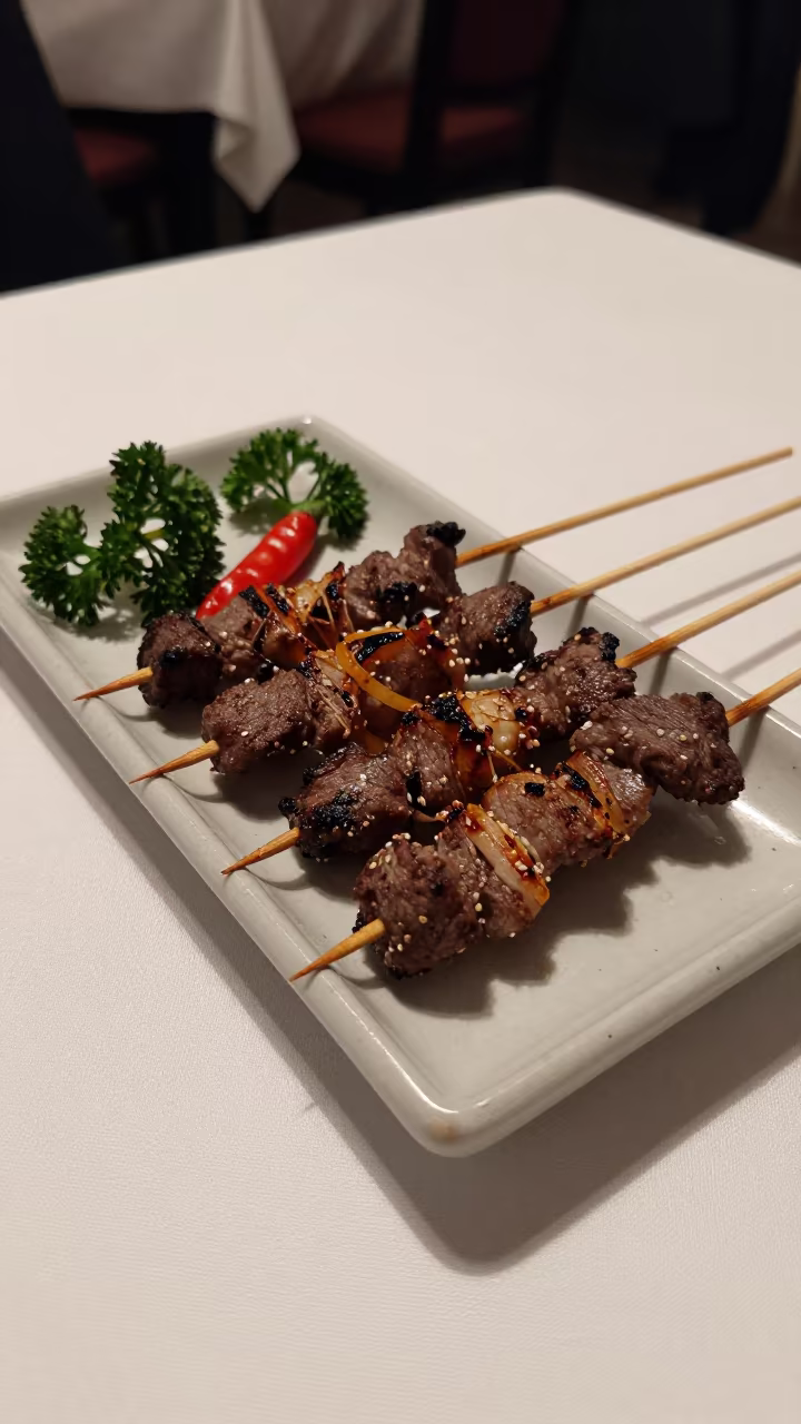 Sate Skewers on Charcoal Tray Vadodara in on a linen-covered restaurant table in Vadodara