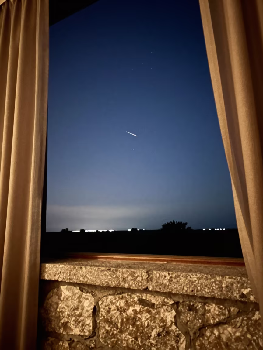 Satellite Trail Over Stone Ledge in Dawn Light in on a stone ledge in Ulhasnagar