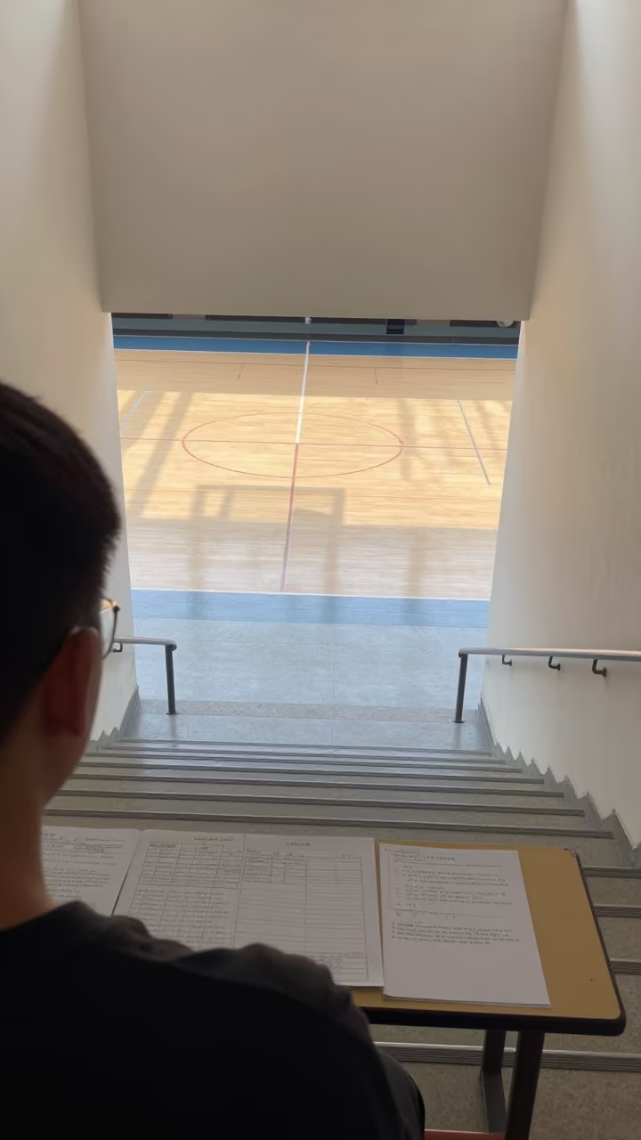 School Staircase Overlooking Basketball Court in at a seminar table covered in notes in Kahramanmaraş