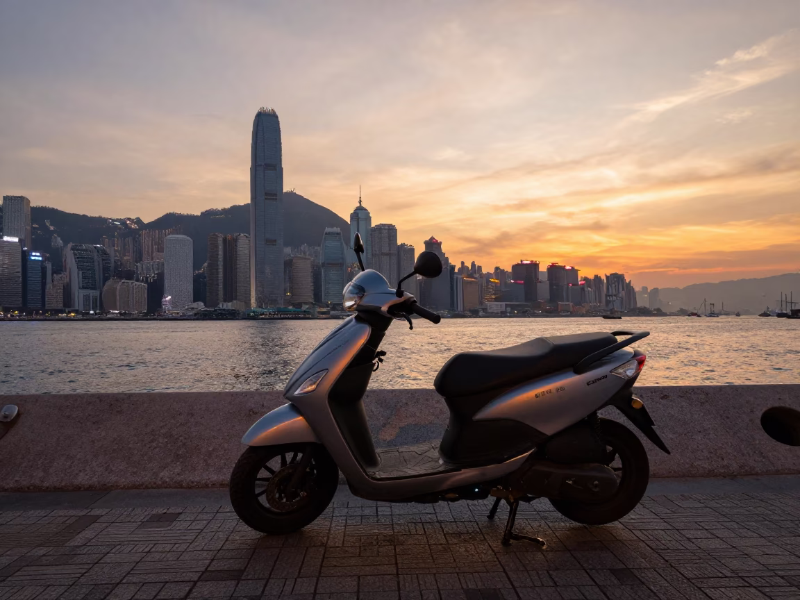 Scooter parked on harbor promenade at sunset in Hong Kong with evening light in in Hong Kong, Hong Kong