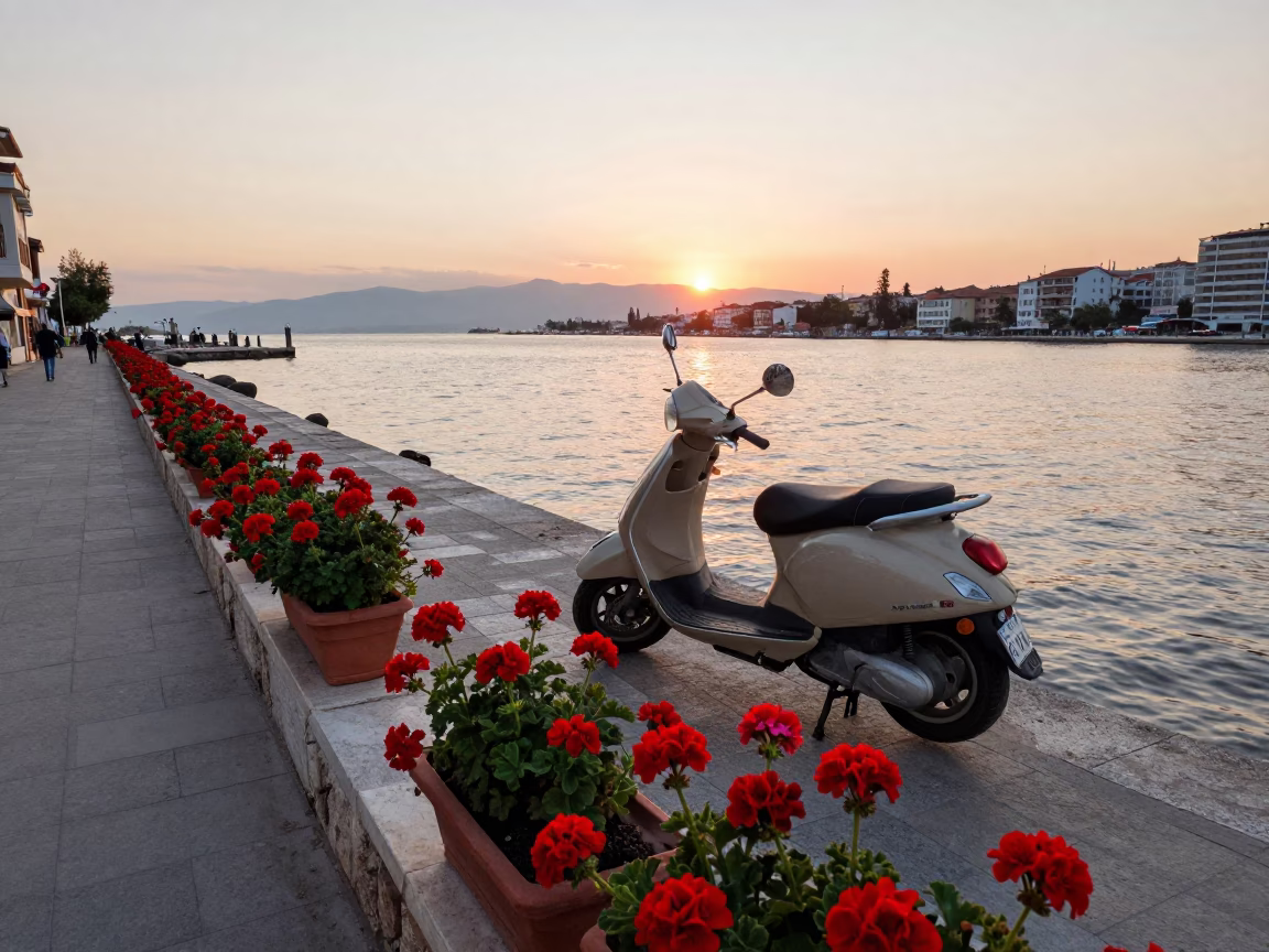 Scooter parked on Izmir harbor promenade with geraniums in early evening in in Izmir, Turkey