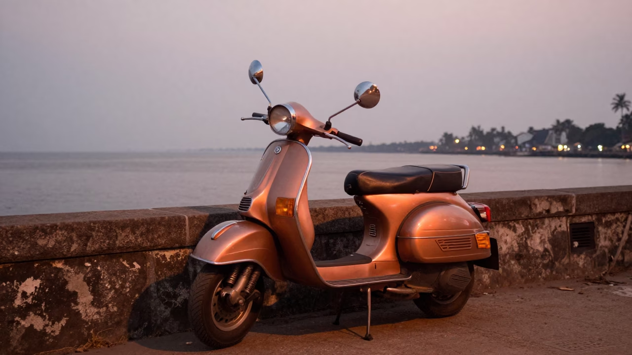 Scooter parked on Kochi harbor promenade in copper-toned light before dusk in in Kochi, India