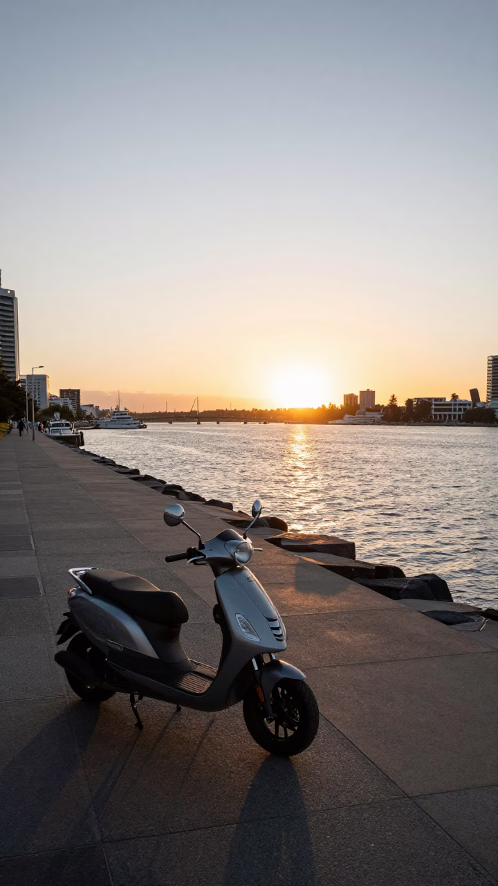 Scooter parked on Perth harbor promenade at sunset with city skyline views in in Perth, Western Australia, Australia
