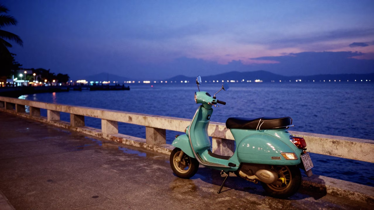 Scooter parked on Phuket harbor promenade during indigo twilight with colorful local street life in in Phuket, Thailand