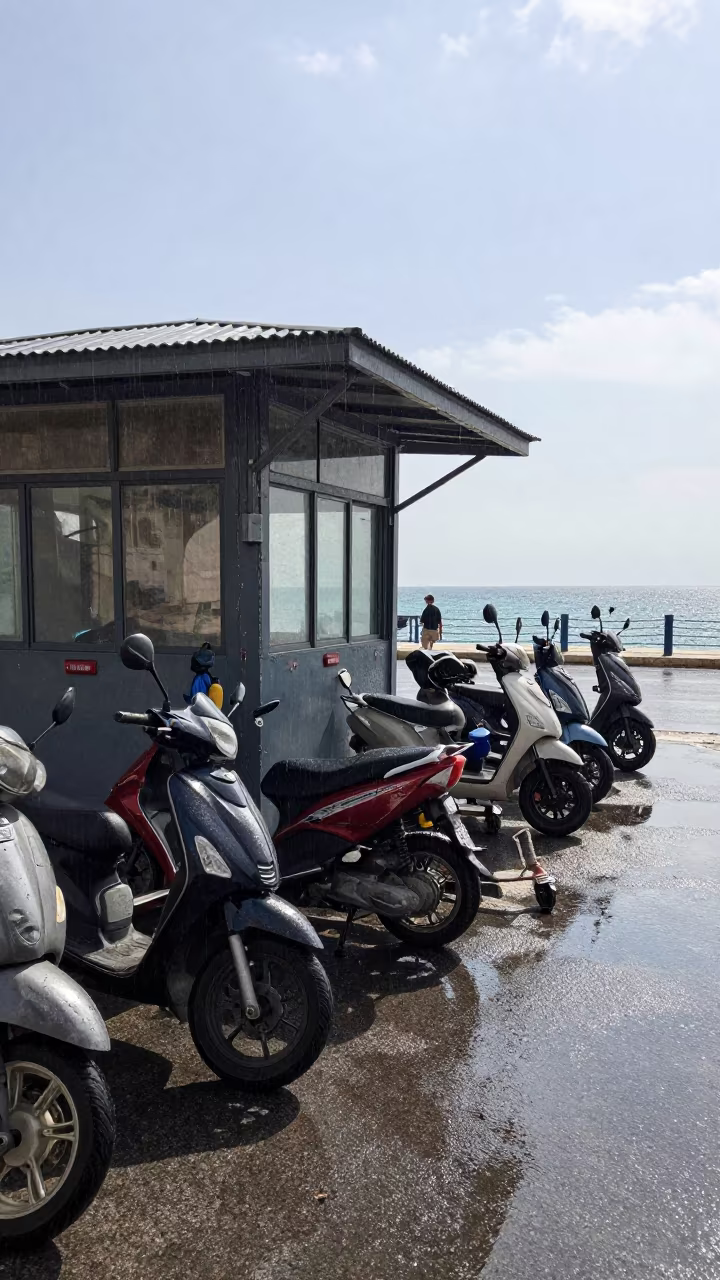 Scooter Reflections Rainy Night Market Puddle in by a rain-darkened kiosk in Nicosia