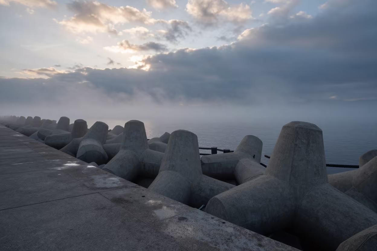 Sea Fog Crawls Over Busan Breakwater at Dawn in at a canal lock chamber near Busan
