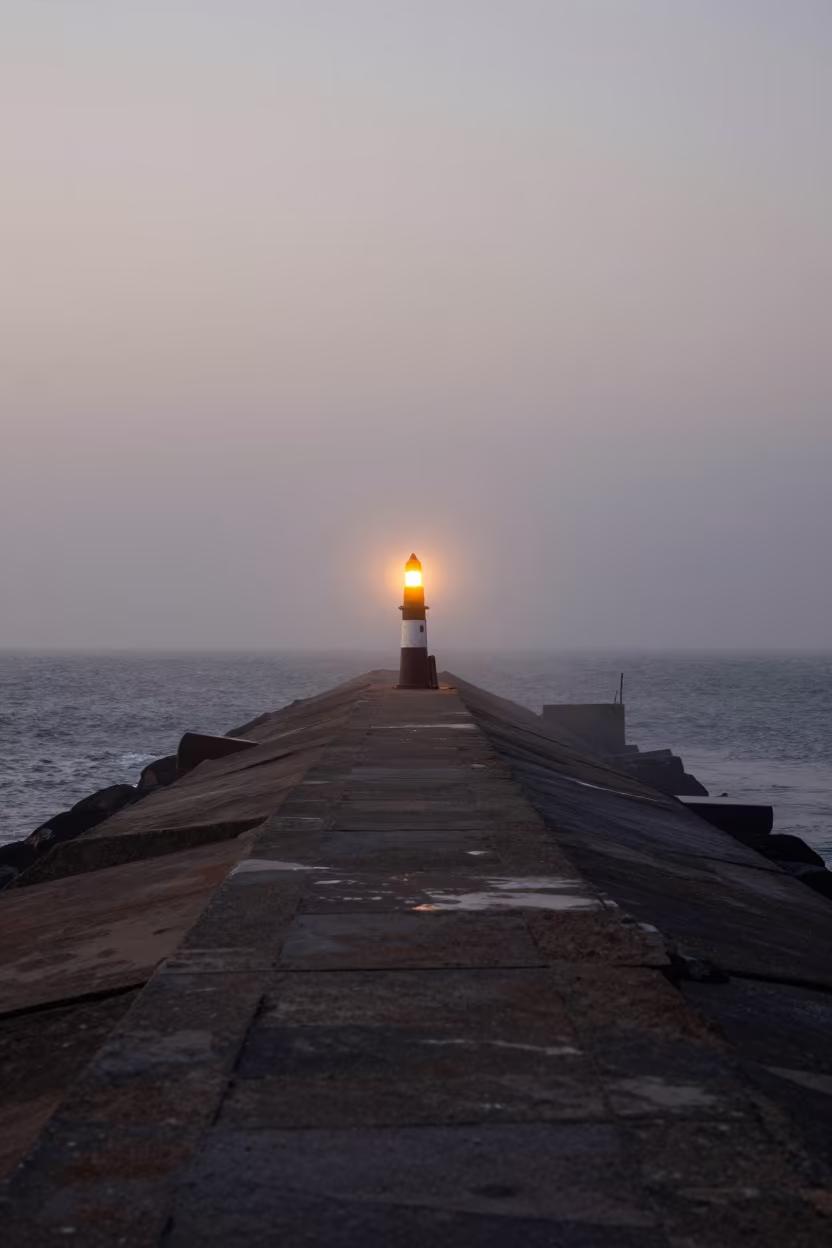 Senegal Breakwater Beacon Blinking in Dawn Mist in across a windy overpass interchange in Senegal