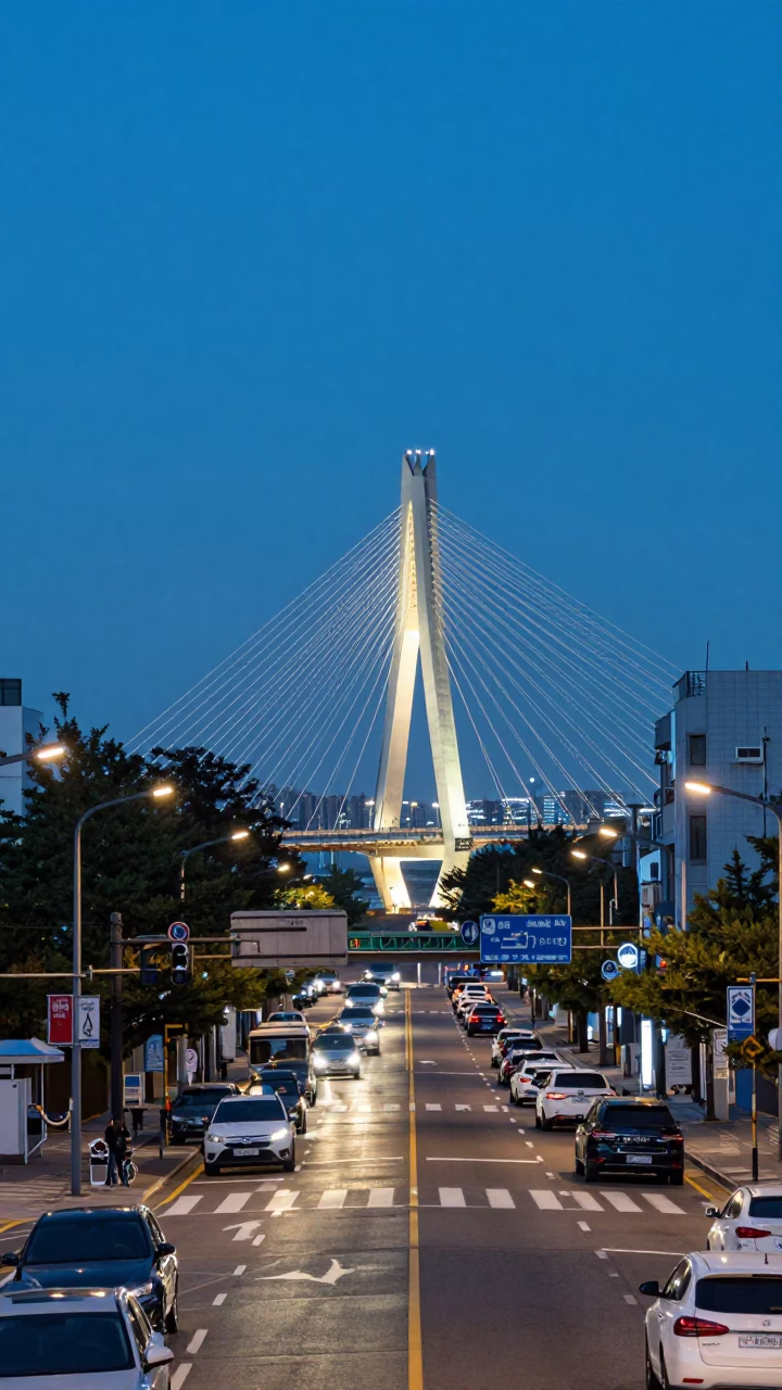 Seoul Evening Street Scene with Cable Stayed Bridge Illuminated Against Dark Harbor in in Seoul, South Korea