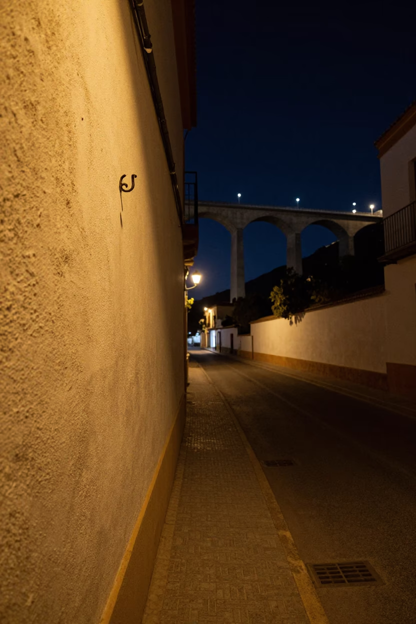 Seville Night Street Scene with Wall Hook and Concrete Viaduct in Background in in Seville, Spain