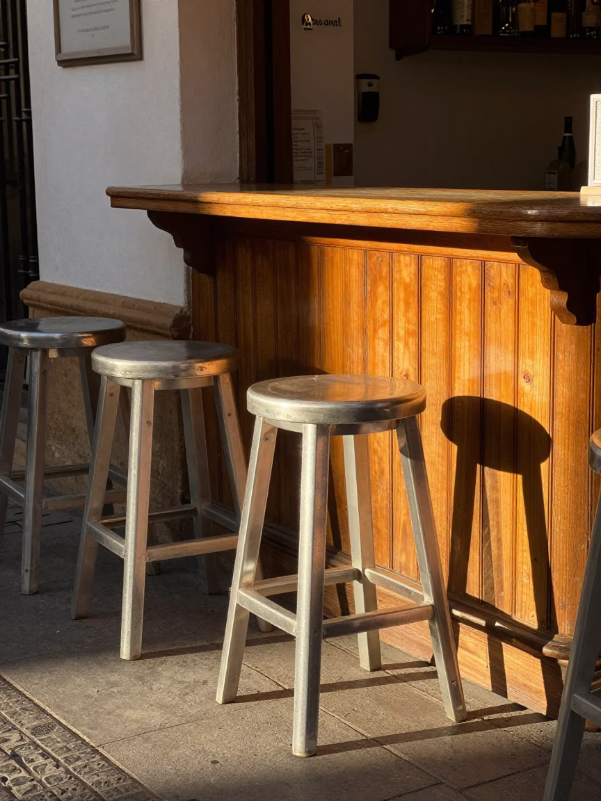 Seville Spain Late Afternoon Sunlight Striking Bar Stools and Clear Glass Doorframe in in Seville, Spain