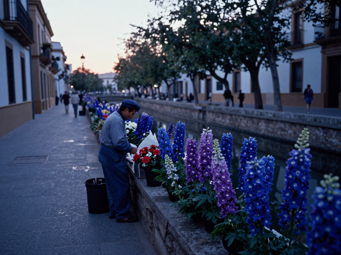 Seville Spain Pre-Dawn Street Scene with Delphinium Flowers and Canal Reflections in in Seville, Spain