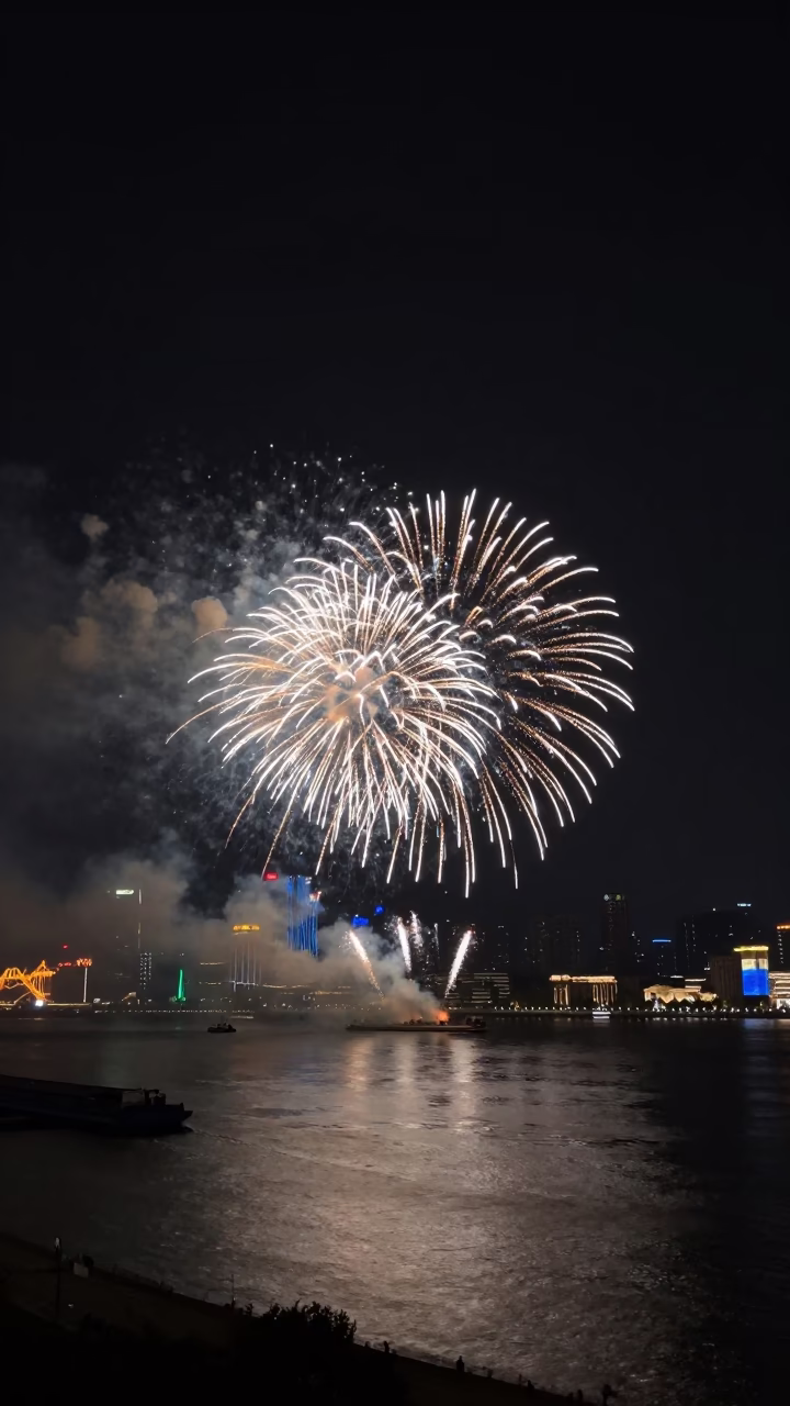 Shanghai Harbor Night View with Fireworks and Distant City Skyline in in Shanghai, China