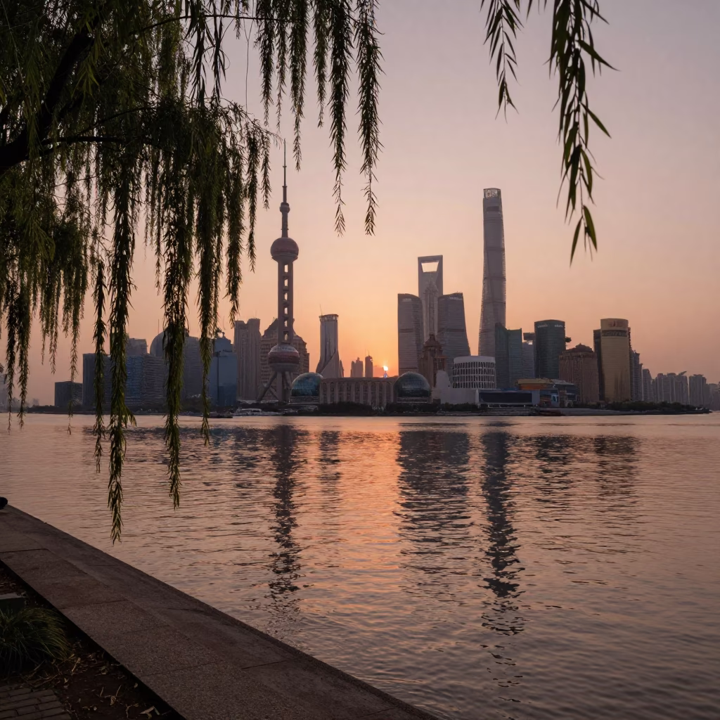 Shanghai Huangpu River dusk with weeping willow branches over calm water and distant skyline in in Shanghai, China
