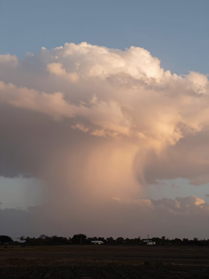 Shelf Cloud Wall Over Willemstad Plain at Dusk in across a storm-bright plain near Willemstad