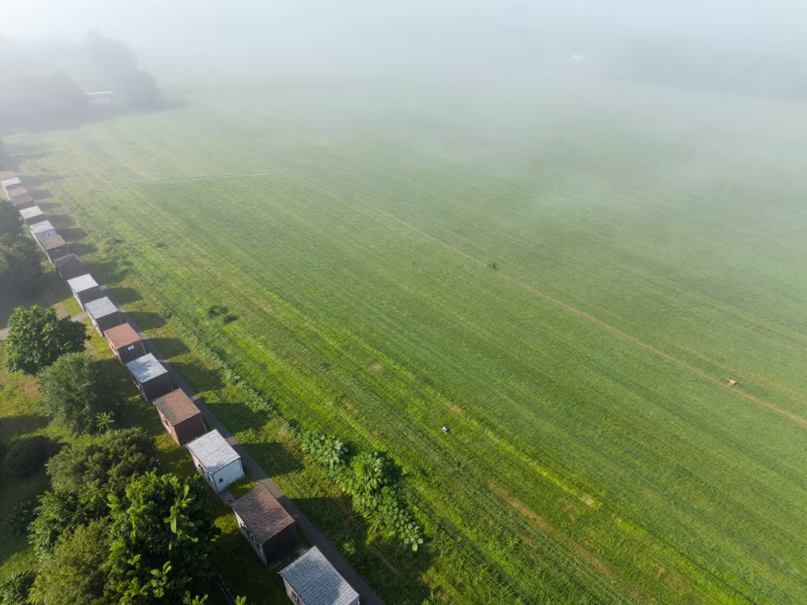 Shoebox Villages on Storm-Bright Midsummer Hillside in across a storm-bright plain near Leipzig