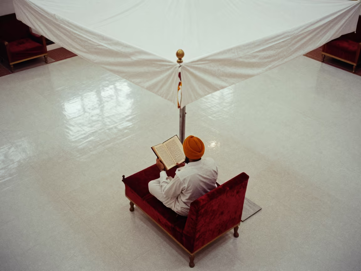 Sikh Granthi Reading Guru Granth Sahib Under Canopy in on a velvet chair near Bangalore