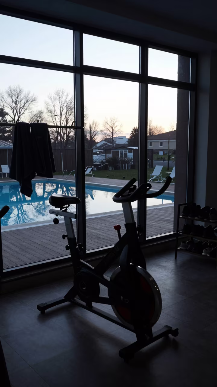 Silhouette of Spin Bike in Dawn Light in on an indoor lap-pool deck before open swim in Balıkesir