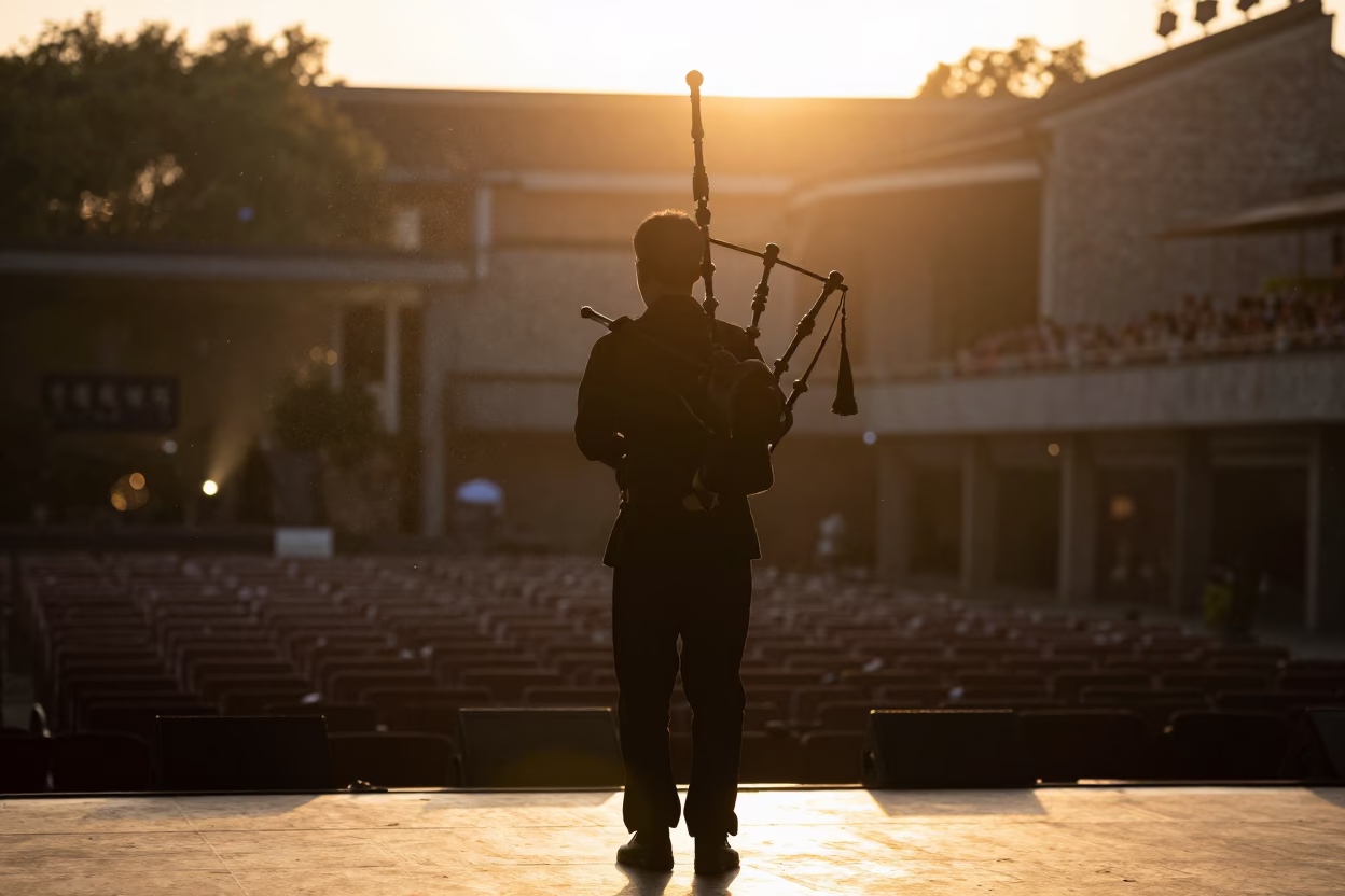 Silhouetted Bagpiper Backstage Golden Hour Ningbo in on a dimly lit stage in Ningbo