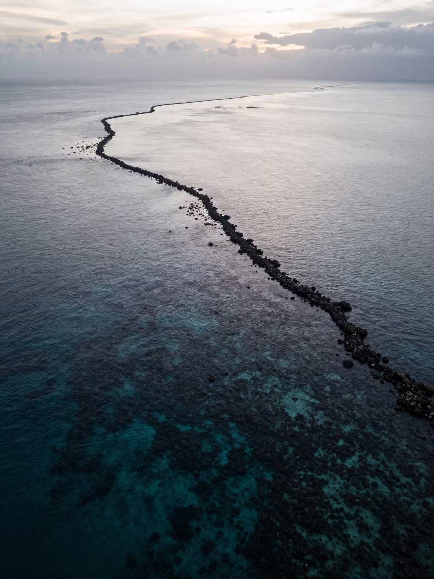 Silhouetted Barrier Reef in Silver Dawn Light in beside a reef crevice under clear water near Cebu