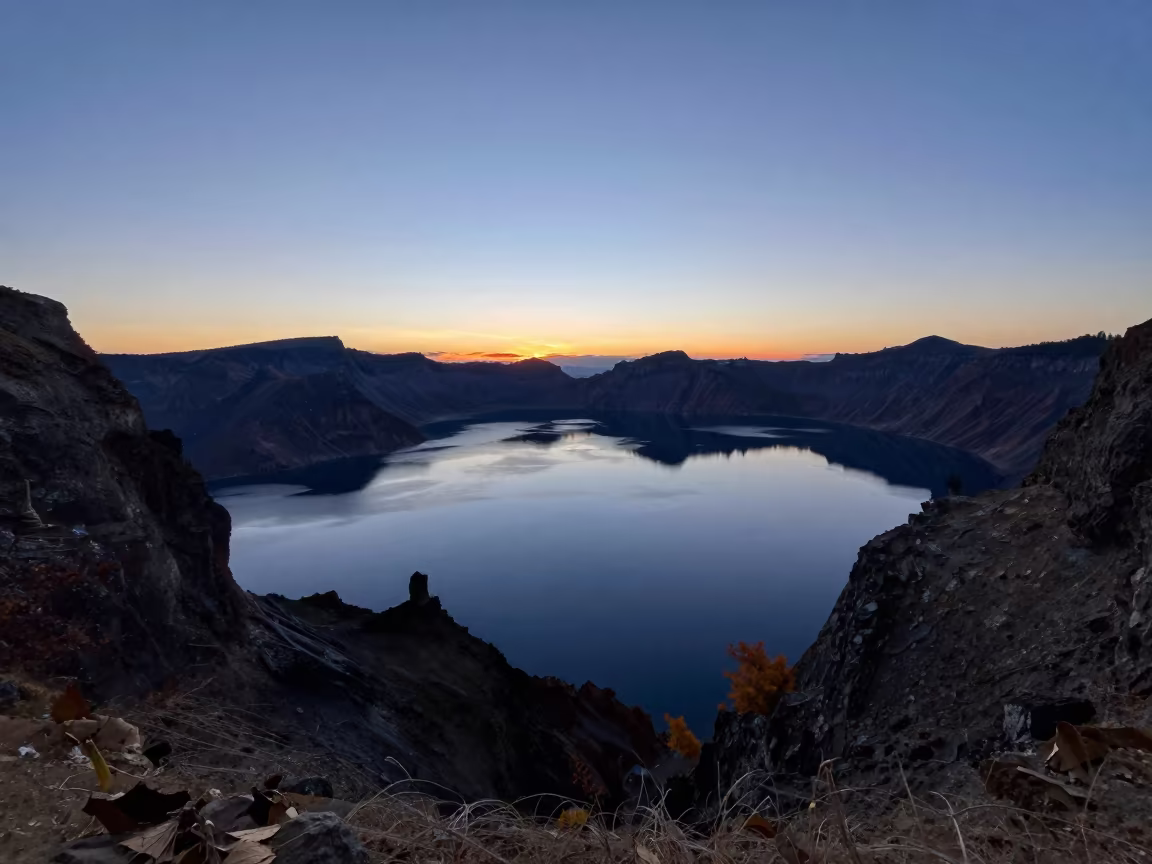 Silhouetted Cone Lake in Indigo Twilight Fog in from a ridge above layered foothills near Kot Addu