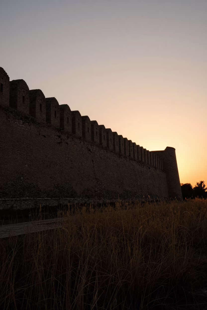 Silhouetted Curtain Wall Ruins at Tashkent Sunset in through a courtyard reclaimed by grasses near Tashkent