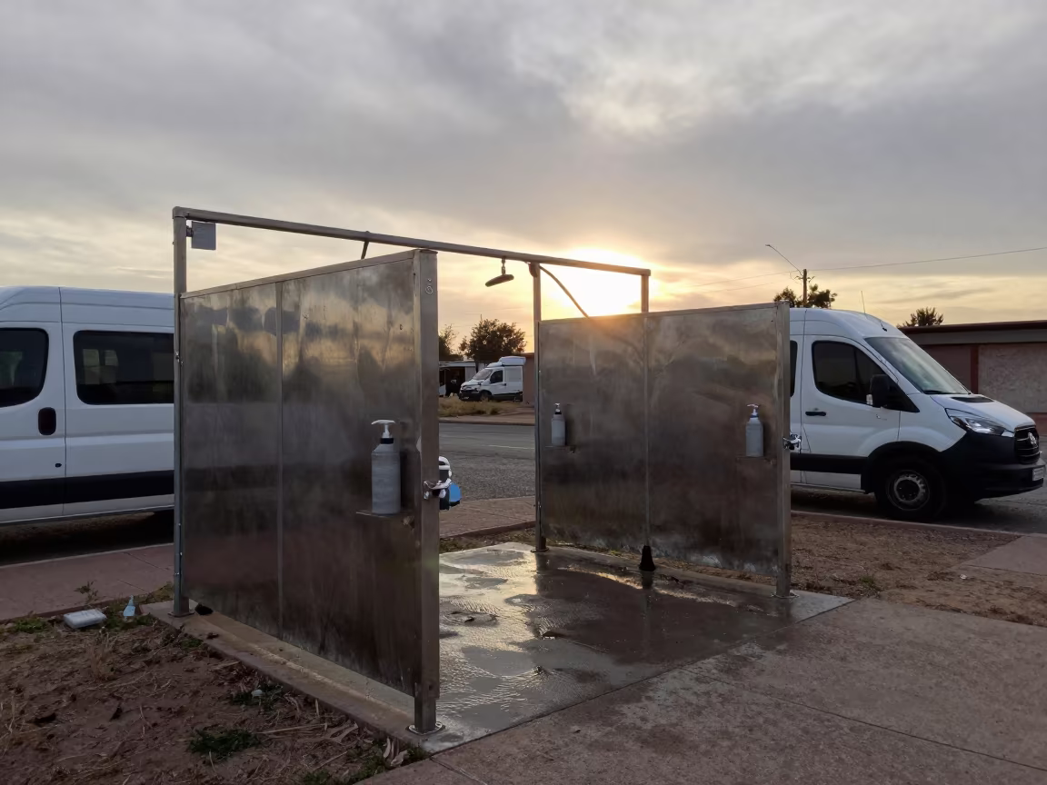Silhouetted Dog Wash Station at Sunset in Tarija in outside a grooming van on a curbside stop in Tarija
