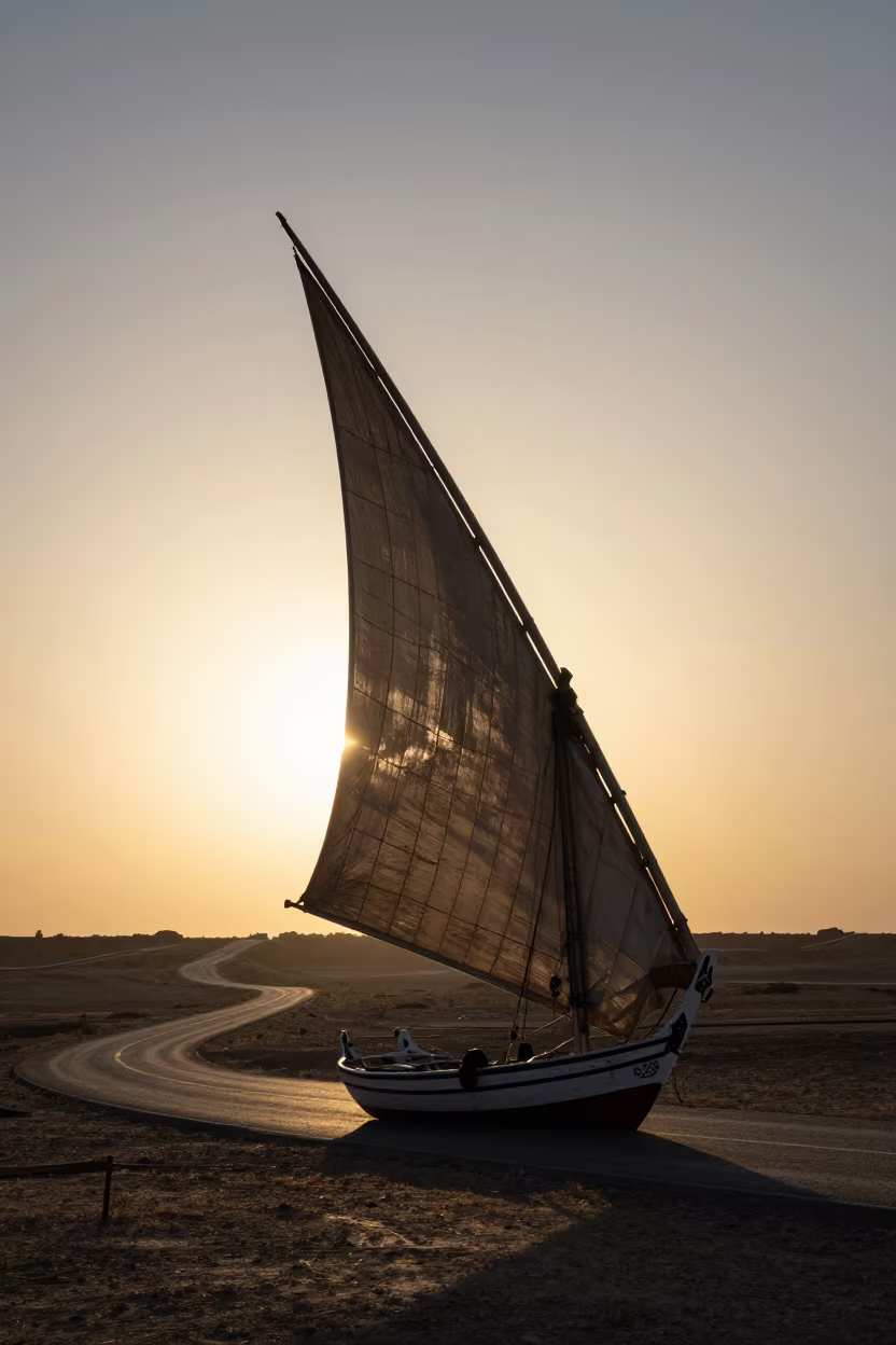 Silhouetted Felucca Sail at Sunset in along a switchback approach near Tabriz