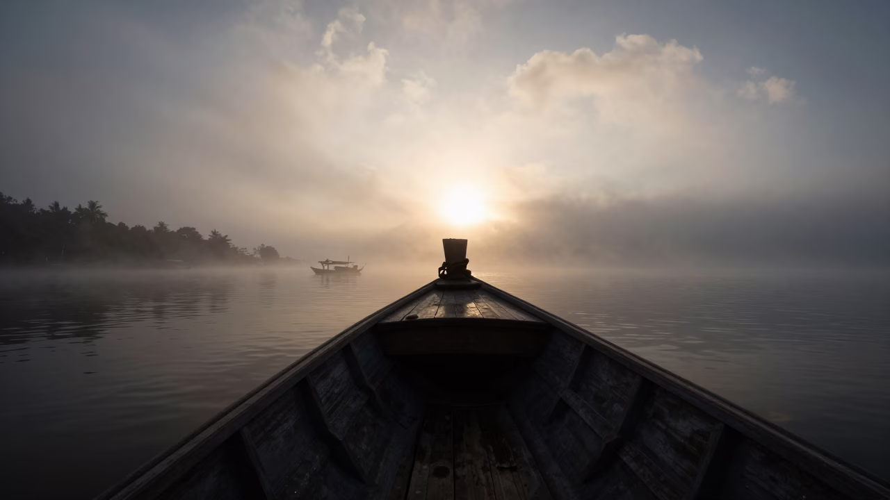 Silhouetted Fishing Boat in Foggy Harbor in beside a fogbound harbor mouth near Chiang Mai
