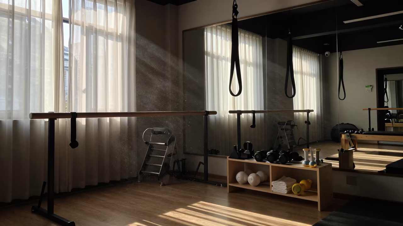 Silhouetted Fitness Rail in Nanjing Studio Morning Light in inside a mirrored studio cleared for class in Nanjing