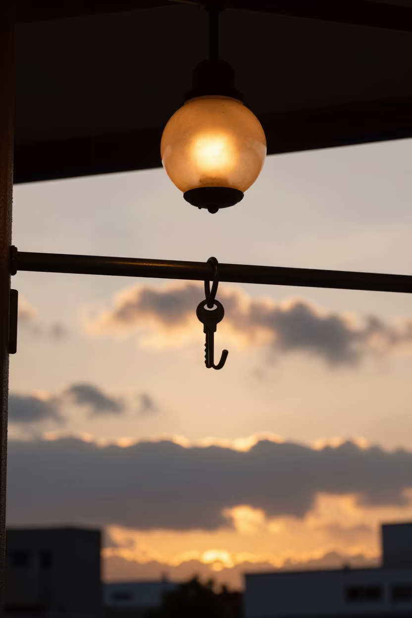 Silhouetted Key Rail Under Amber Porte Cochere Light in beneath a porte cochere at arrival near Fukuoka
