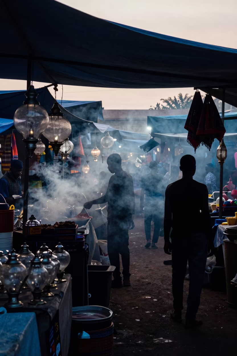 Silhouetted Lantern Sellers Amid Dusk Smoke in under a market canopy in Port Harcourt