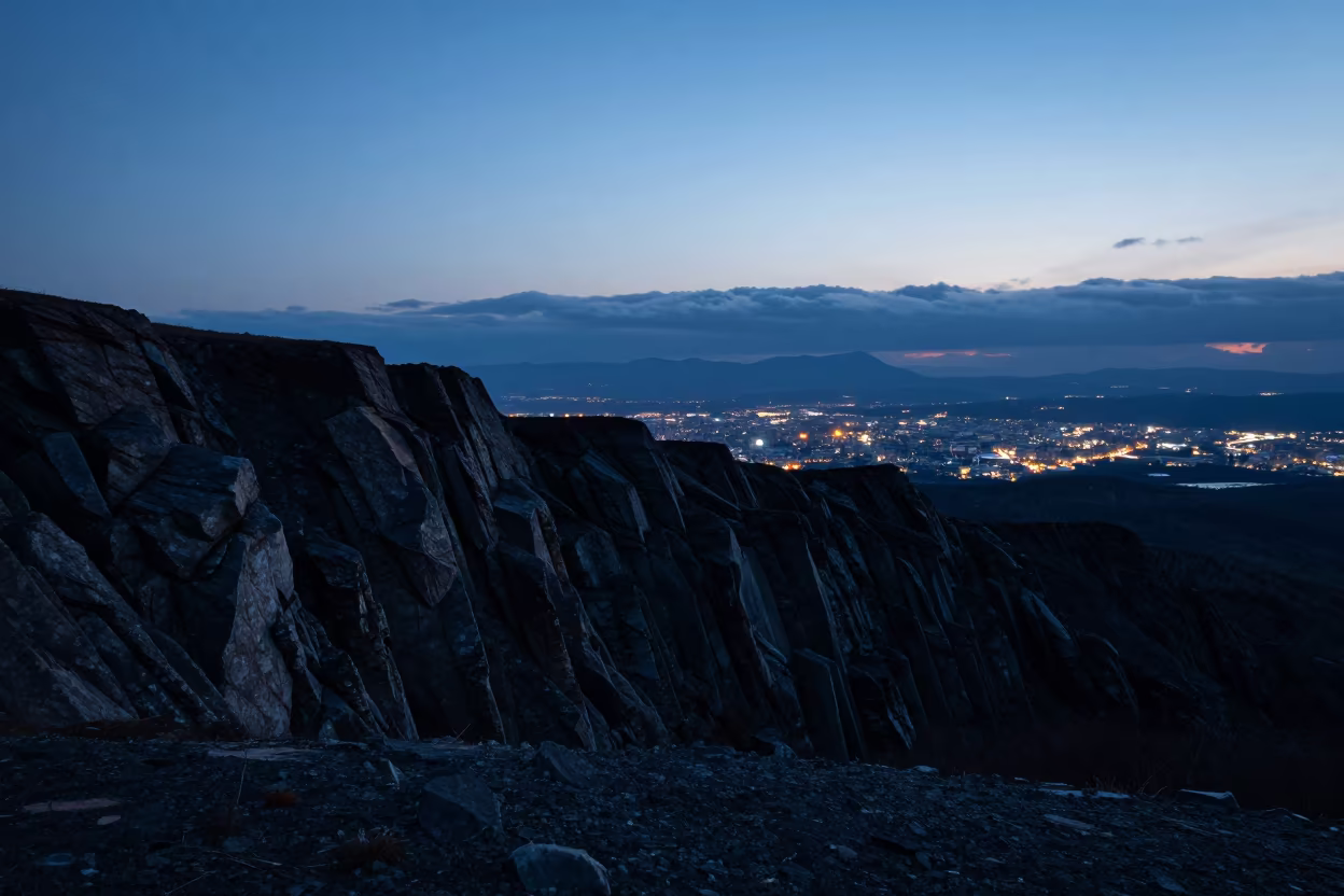 Silhouetted Moraine Wall Against Summer Twilight in from a ridge above layered foothills near Sapporo