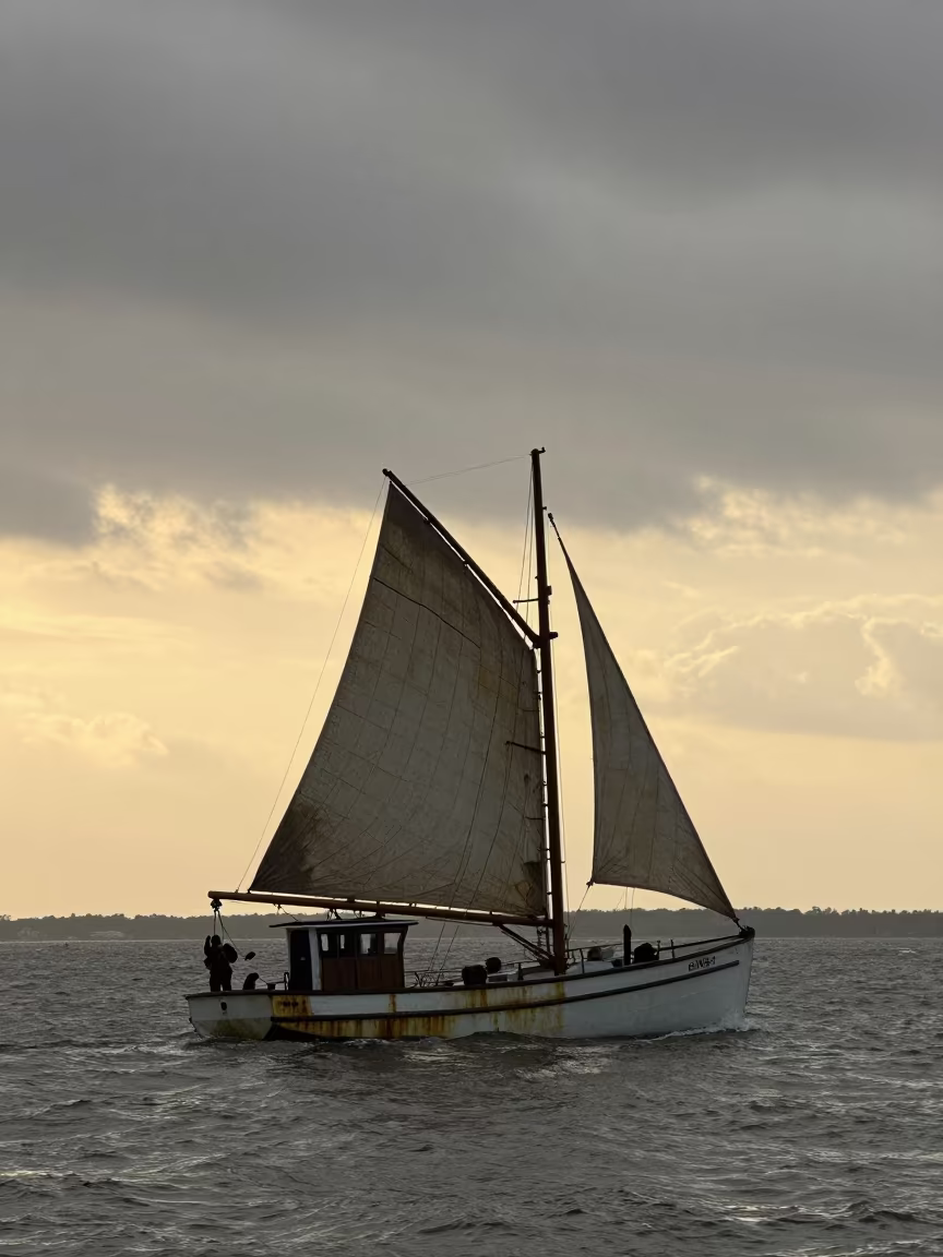 Silhouetted Oyster Dredger Boat at Golden Hour in along a switchback approach in Chad