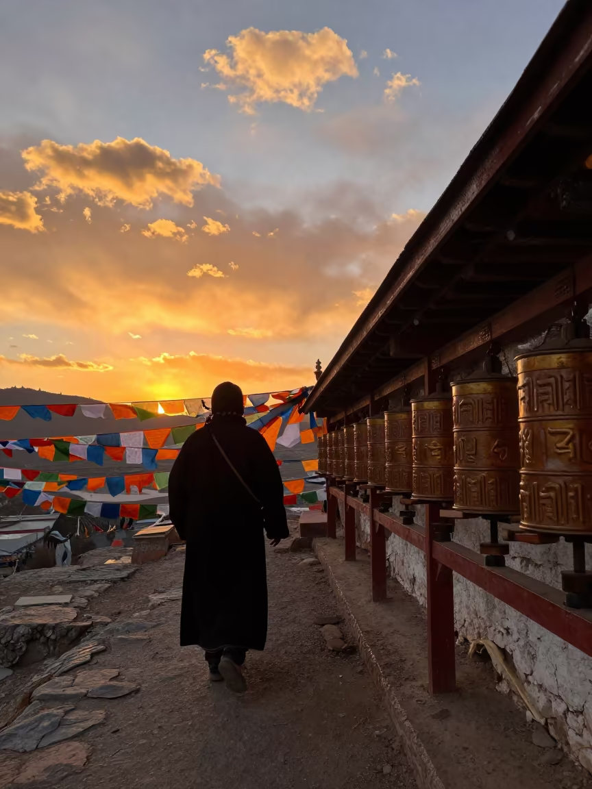 Silhouetted Pilgrims Spinning Wheels at Sunset in along a high mountain pass beneath prayer flags near Lhasa