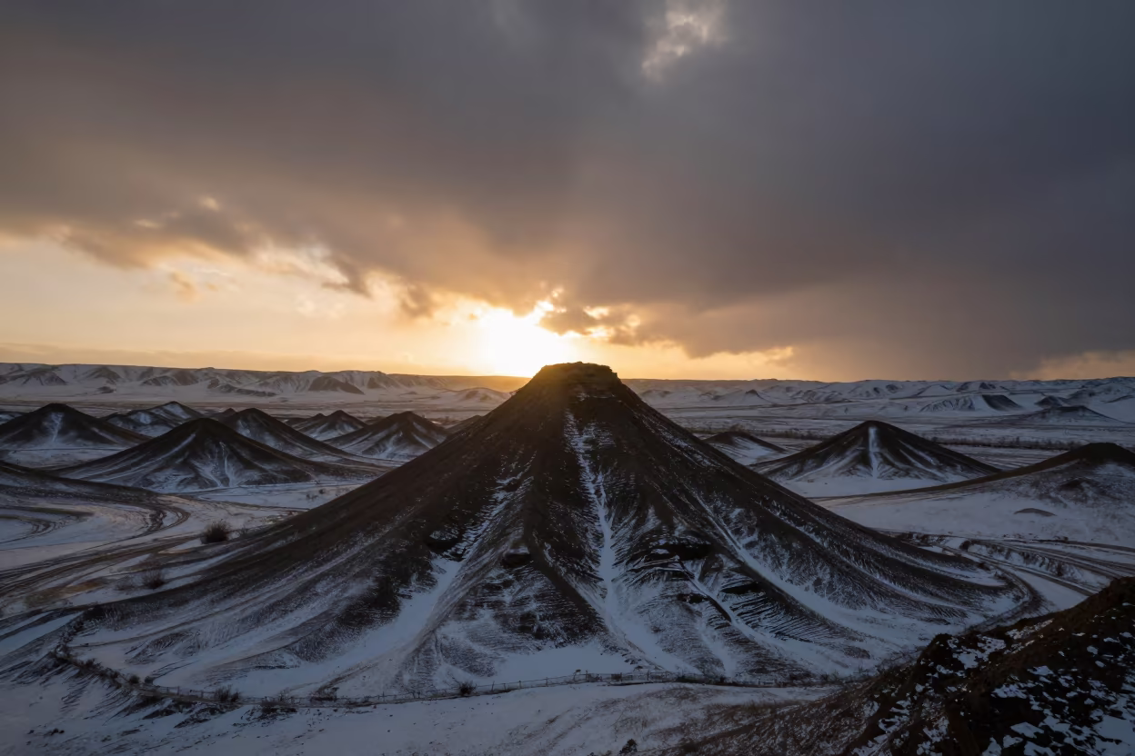 Silhouetted Pingo Mound Winter Valley in across a wide valley floor in Armenia
