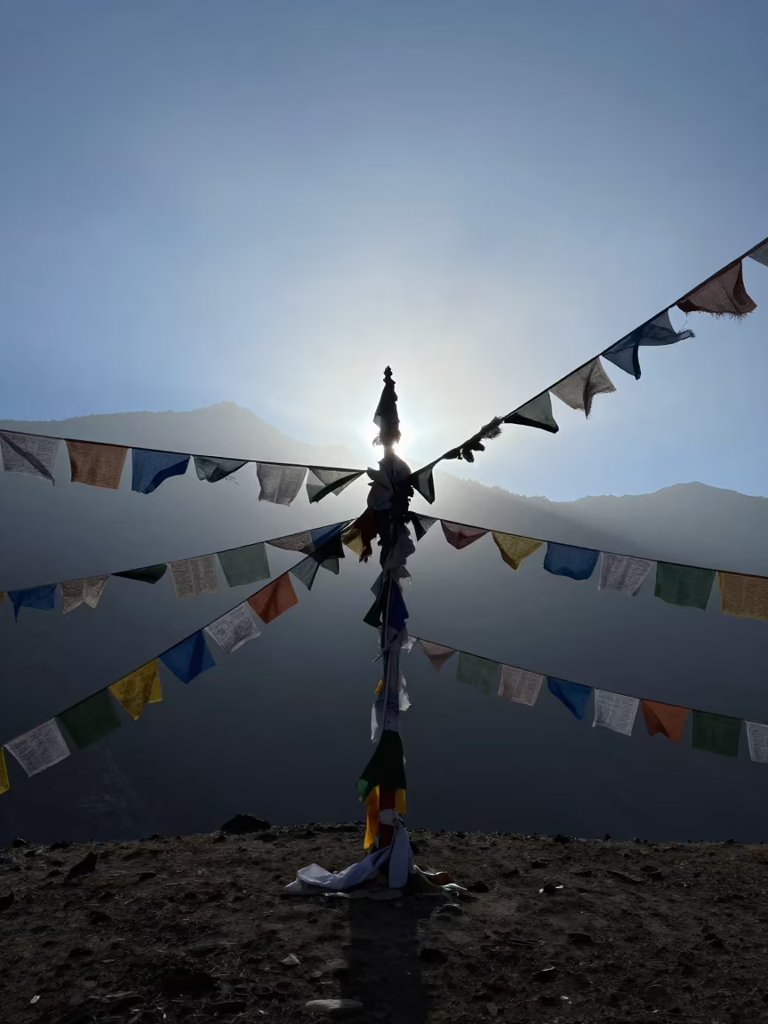 Silhouetted Prayer Flags in Misty Thimphu Evening in along a high mountain pass beneath prayer flags near Thimphu
