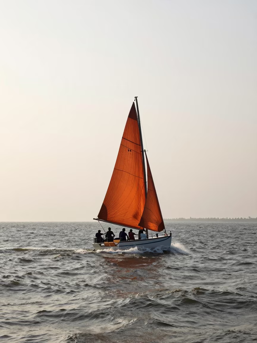 Silhouetted Sailboat Spinnaker Karnataka Ferry Evening in across a remote ferry crossing in Karnataka