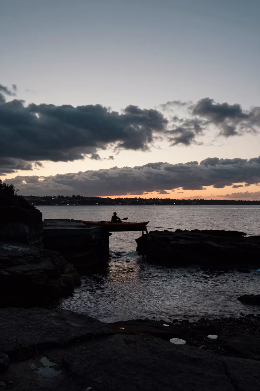Silhouetted Sea Kayak at Sydney Tidal Cave Entrance in along a switchback approach near Sydney