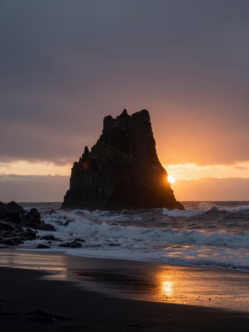 Silhouetted Sea Stack in Icelandic Storm Light in across a floodplain after rain in Iceland