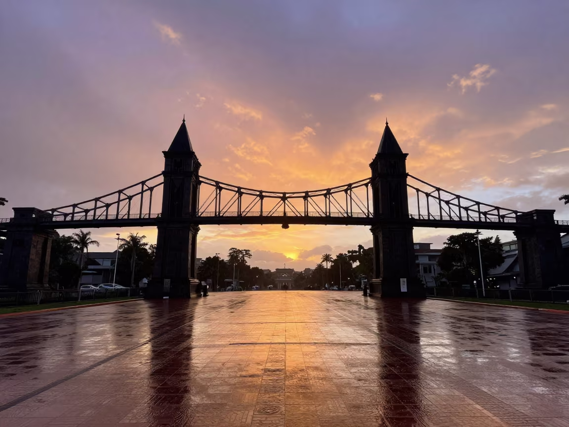Silhouetted Skyway Bridge at Sunset in Fort Portal in across a formal civic plaza in Fort Portal