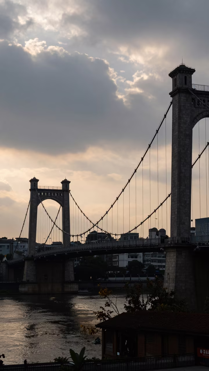 Silhouetted Suspension Bridge in Guiyang Clouds in beside a canal-front facade near Guiyang