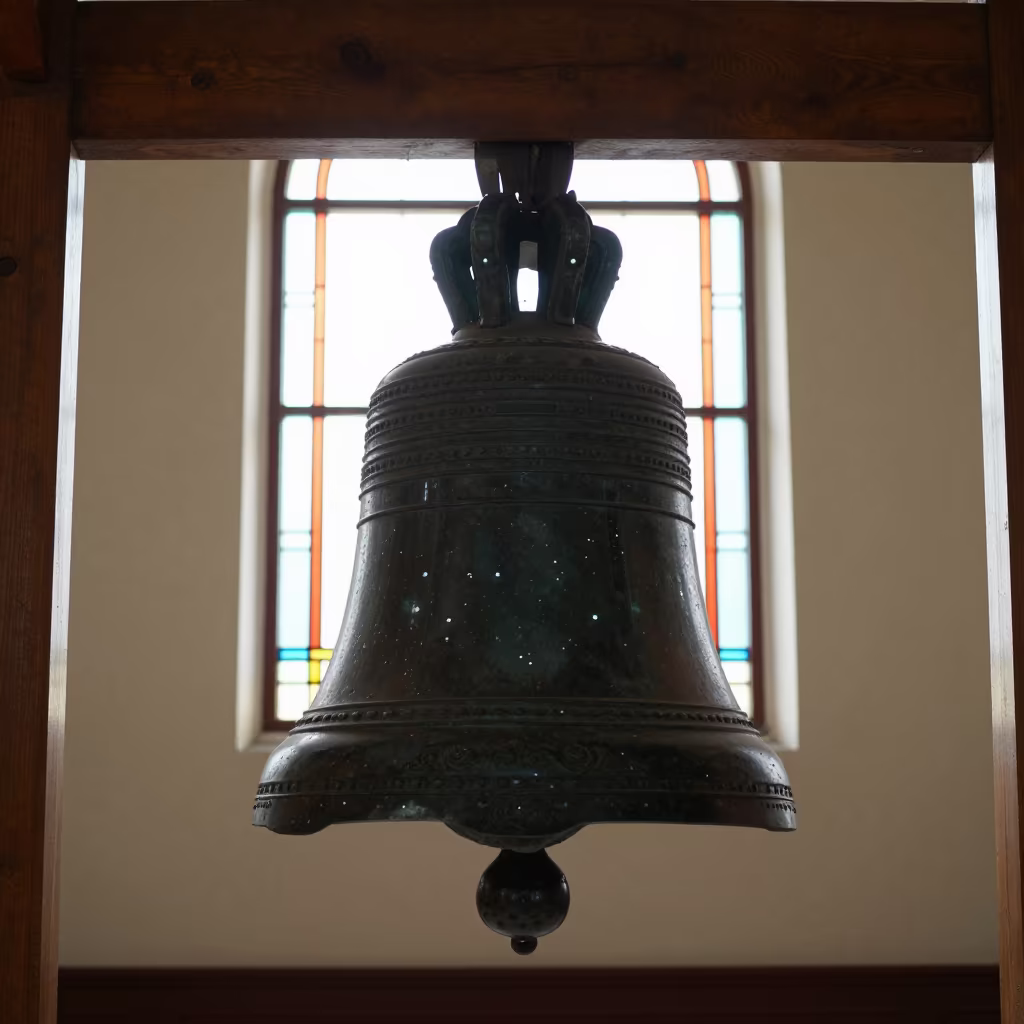 Silhouetted Temple Bell in Ulaanbaatar Chapel in in a chapel lit by stained glass in Ulaanbaatar