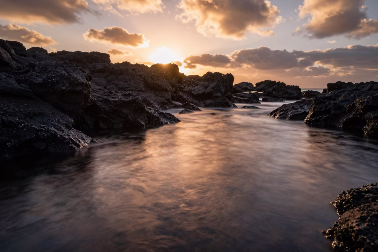 Silhouetted Tide Pools Under Copper Clouds in beside a volcanic drop-off near Cape Town
